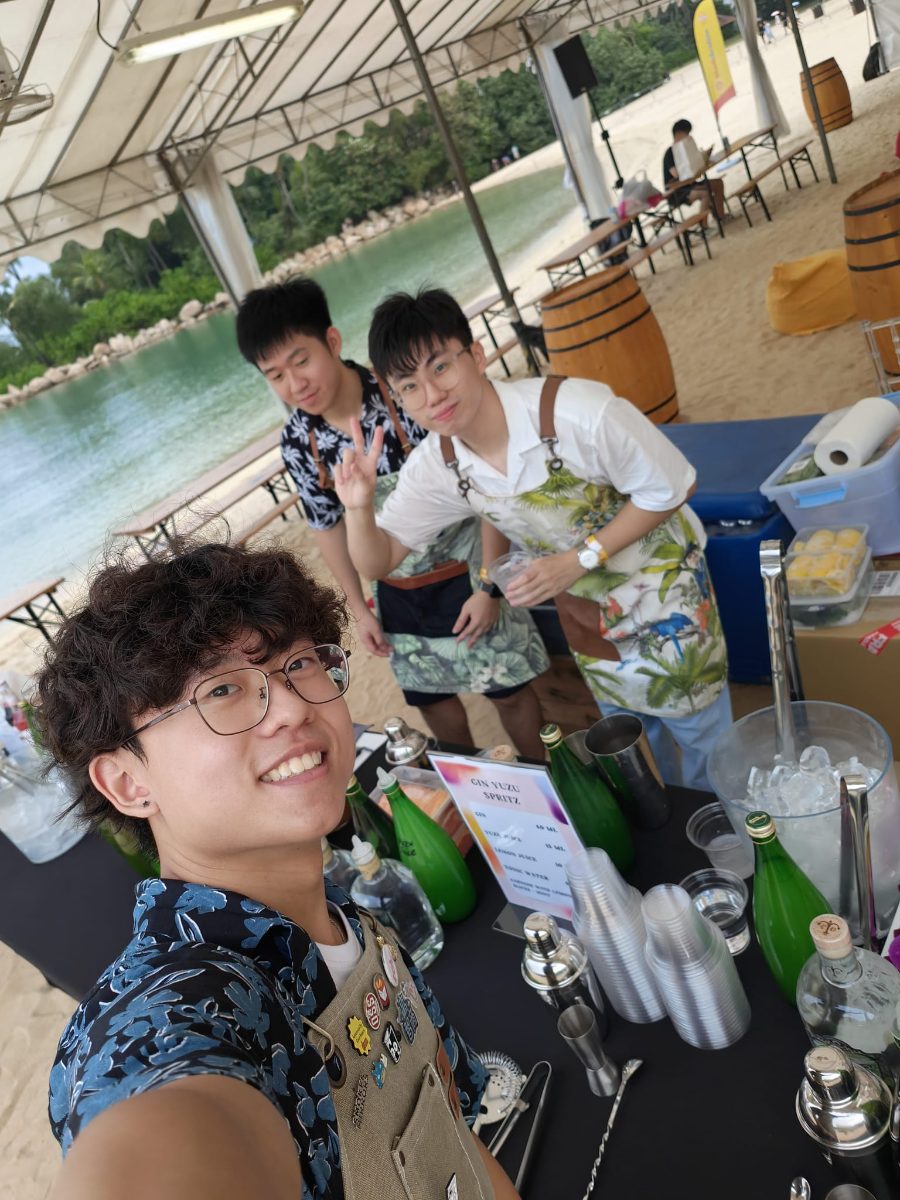 Friends mixing drinks at an outdoor table